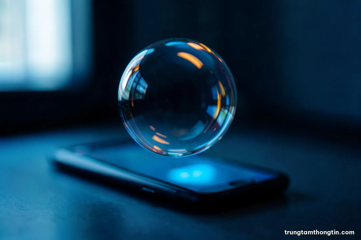 Close-up of a transparent soap bubble floating above a dim office desk, reflecting a blurred smartphone glow, shallow depth of field, cool cyan and deep navy palette
