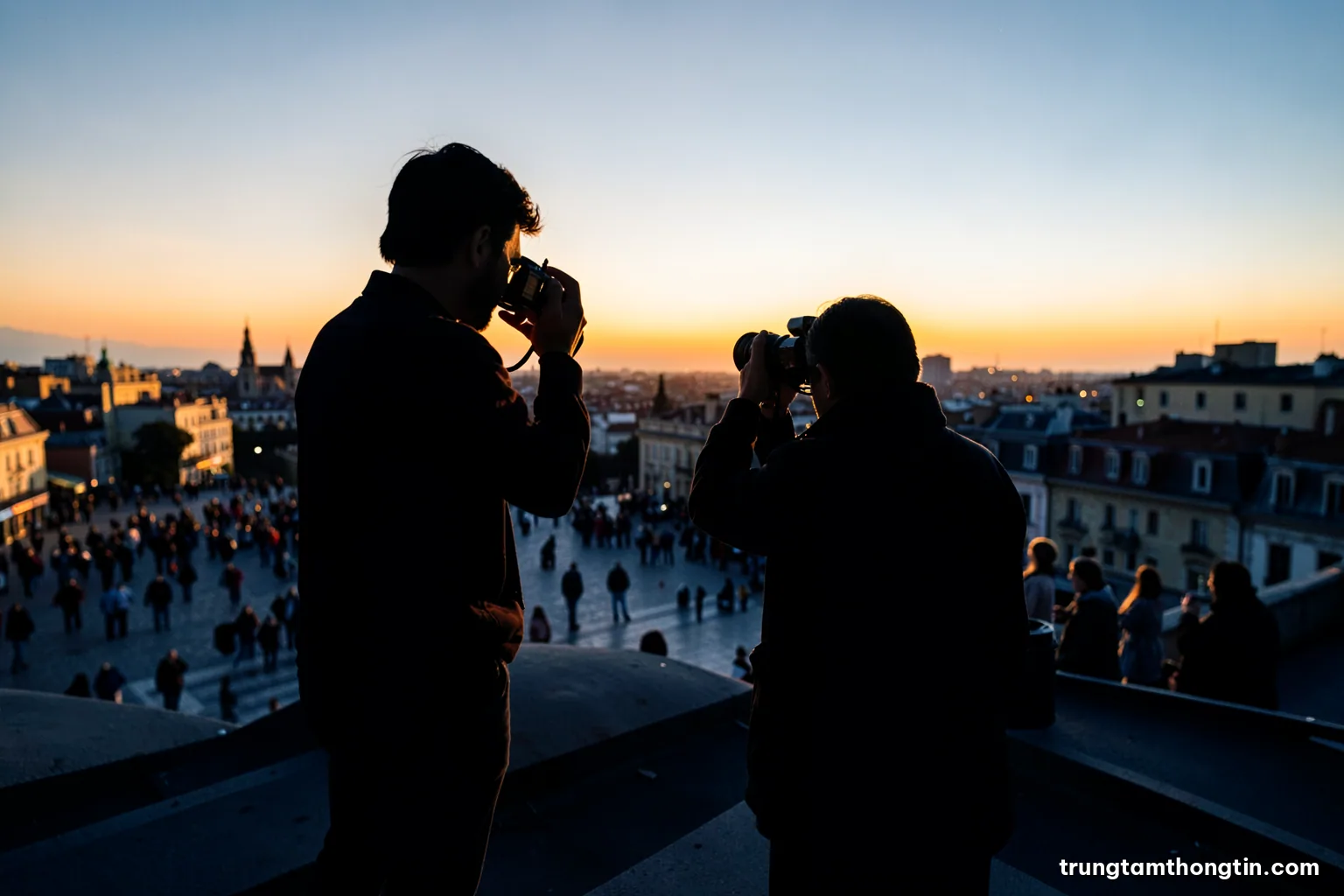Low angle shot of a photographer silhouetted on a rooftop at golden hour, camera raised toward a distant crowd in a city square, long shadows, warm orange and slate blue